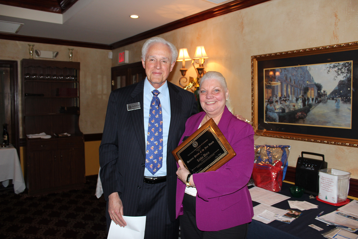In the picture: 1991 Winner and board member Bruce Bristol presents the 2014 Business Person of the Year Award to Linda Dora.
